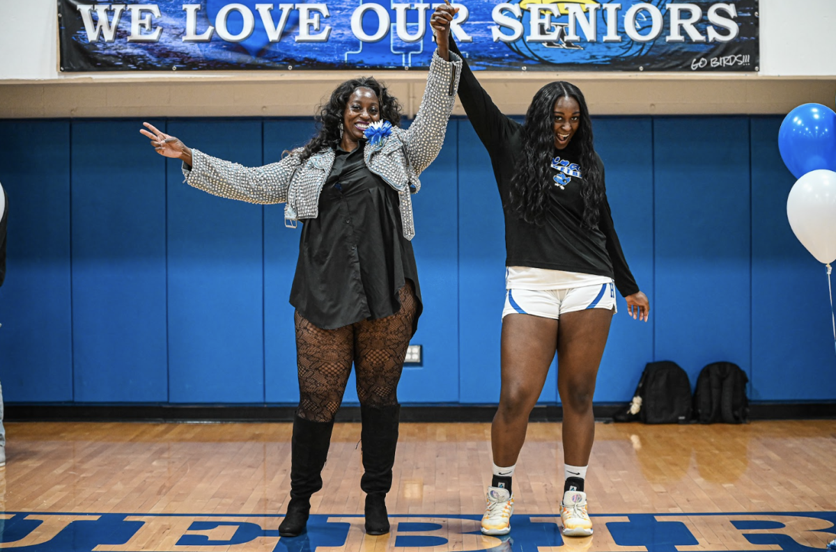 Ty Berry (12) celebrates with her mom for basketball senior night. 